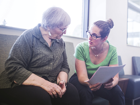 senior adult woman filling out paperwork