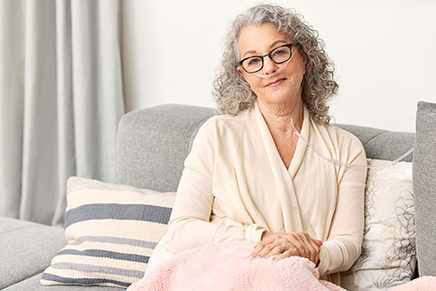 Oxygen WhiteWoman SittingOnCouch NasalCannualas