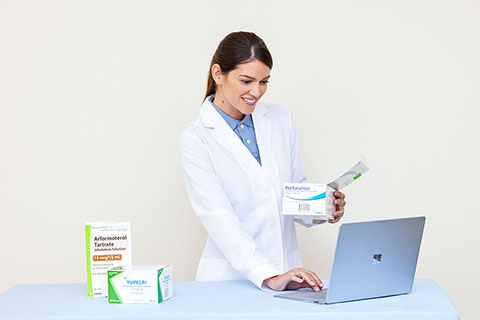 Female Pharmacist with Laptop and Unit Dose Medications like Arformoterol